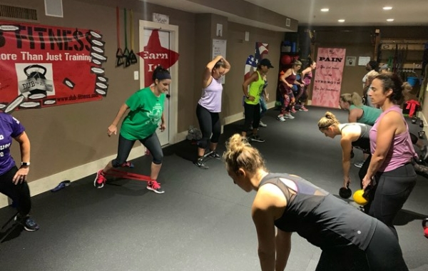Group of people doing exercise in a room