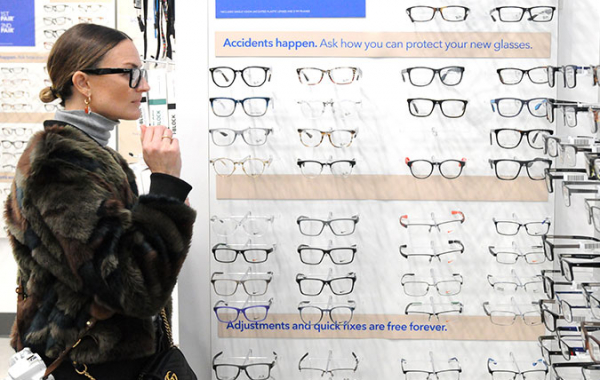 person standing by glasses display