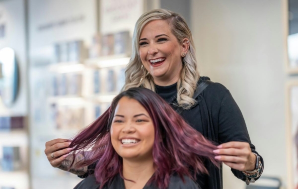 person holding out another person's vibrantly colored hair